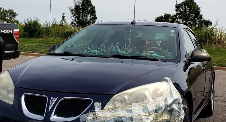 This image has an empty alt attribute; its file name is dino_car.jpg